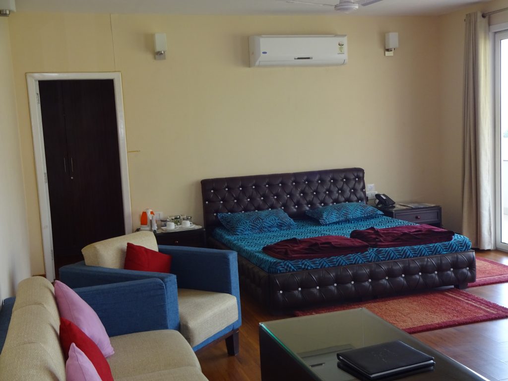 CSI Super Deluxe/VIP Room with double bed, armchairs, table and air conditioning